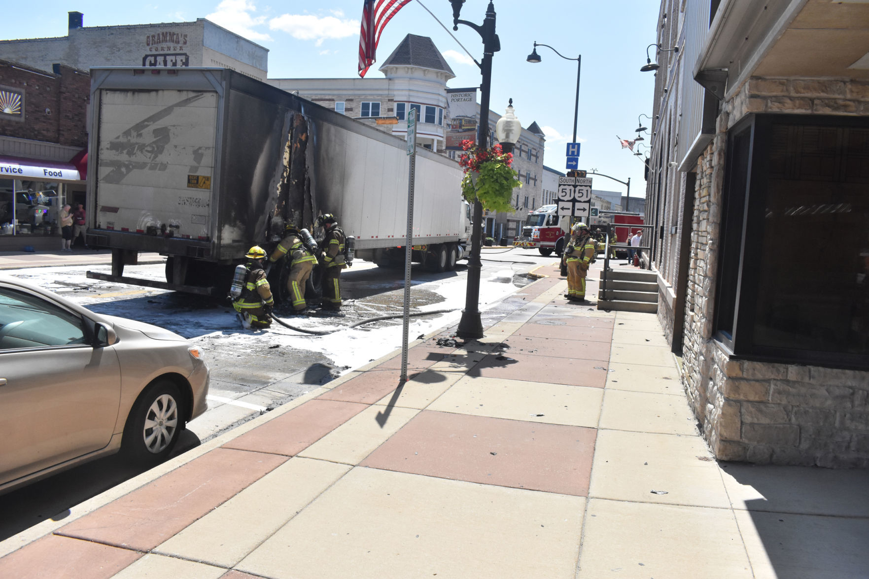 Firefighters inspect damaged trailer